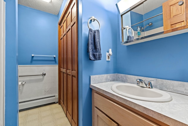 115 Town Farm Rd, East Haddam, CT 06423 - full bath with a baseboard heating unit, vanity, tile patterned floors, and a textured ceiling