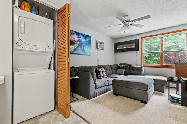 115 Town Farm Rd, East Haddam, CT 06423 - living area featuring estacked washer and dryer, ceiling fan, a textured ceiling, and a wall unit AC