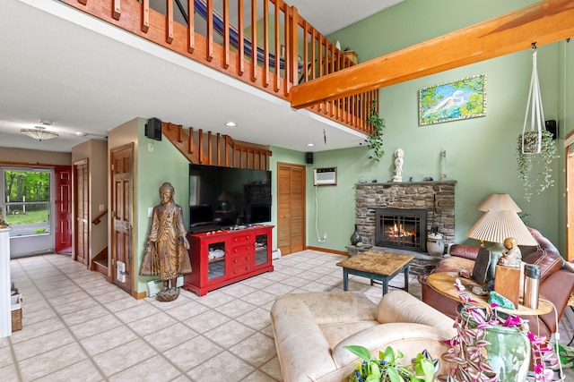 115 Town Farm Rd, East Haddam, CT 06423 - tiled living area with a wall unit AC, a stone fireplace, a towering ceiling, and recessed lighting