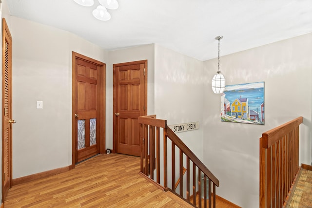 115 Town Farm Rd, East Haddam, CT 06423 - corridor featuring an upstairs landing, wood finished floors, and a chandelier