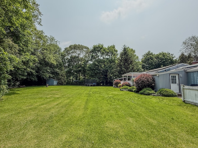 143 Soundview Ave, Shelton, CT 06484 - view of green lawn with a trampoline and a storage unit
