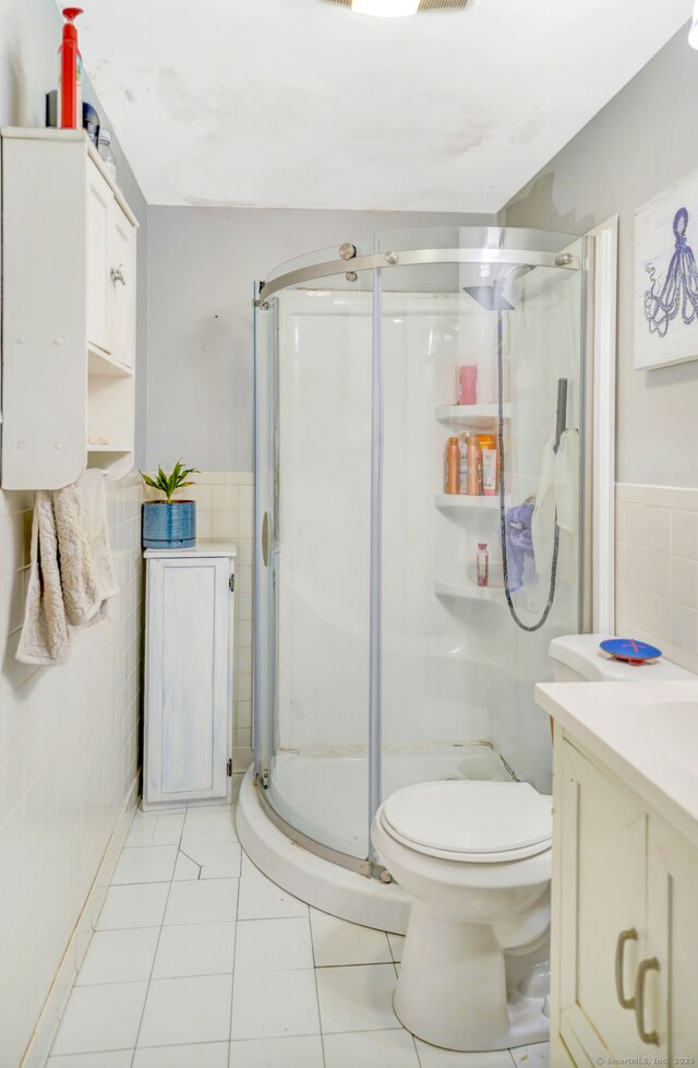 350 S Main St, Naugatuck, CT 06770 - full bath featuring tile walls, tile patterned floors, a shower stall, vanity, and wainscoting