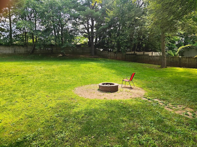 42 Meadowlark Rd, Enfield, CT 06082 - fenced backyard featuring a fire pit