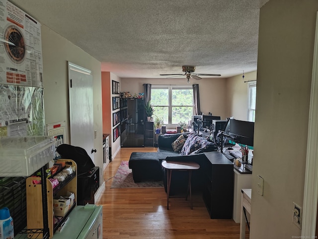 42 Meadowlark Rd, Enfield, CT 06082 - living area with wood finished floors, a ceiling fan, and a textured ceiling