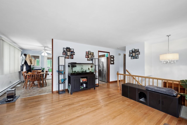 59 Litchfield Ln, Bristol, CT 06010 - living area featuring a ceiling fan, light wood finished floors, a chandelier, and baseboard heating