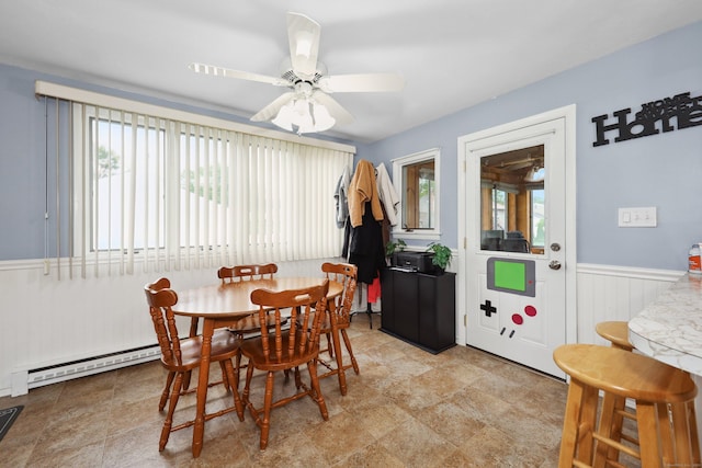 59 Litchfield Ln, Bristol, CT 06010 - dining room featuring a wainscoted wall, a baseboard radiator, and ceiling fan