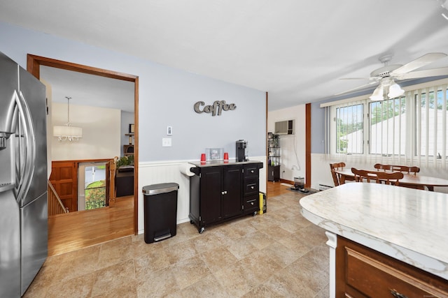 59 Litchfield Ln, Bristol, CT 06010 - kitchen featuring stainless steel refrigerator with ice dispenser, a ceiling fan, a wainscoted wall, and light countertops