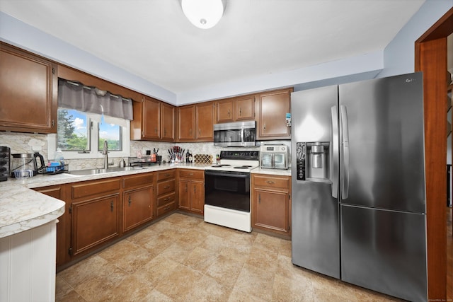 59 Litchfield Ln, Bristol, CT 06010 - kitchen with stainless steel appliances, light countertops, tasteful backsplash, and brown cabinetry