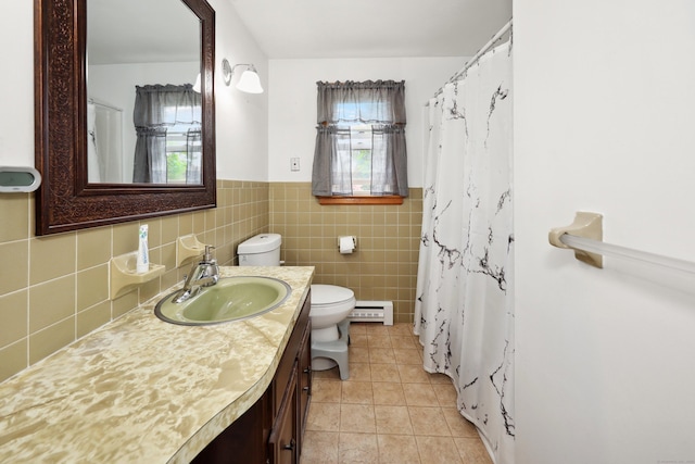 59 Litchfield Ln, Bristol, CT 06010 - bathroom featuring baseboard heating, vanity, healthy amount of natural light, tile patterned flooring, and a wainscoted wall