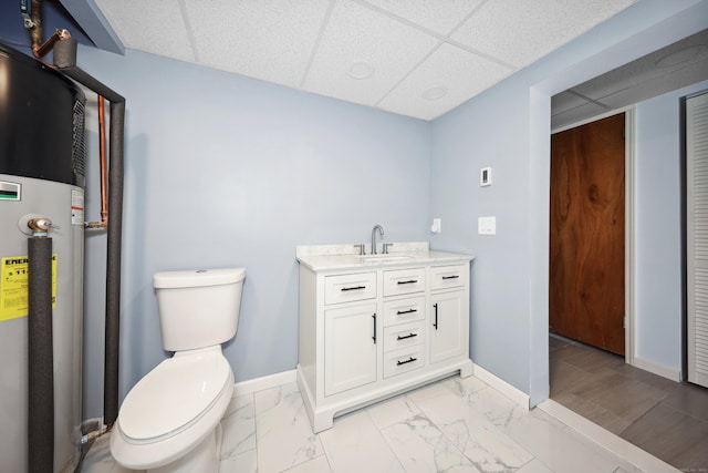 59 Litchfield Ln, Bristol, CT 06010 - bathroom featuring a paneled ceiling, vanity, marble look tiles, and water heater