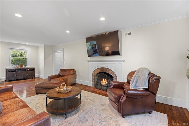 203 Ridgewood Ave, Hamden, CT 06517 - living area featuring a brick fireplace, wood finished floors, crown molding, and recessed lighting