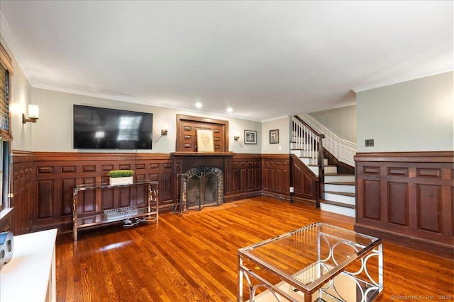 203 Ridgewood Ave, Hamden, CT 06517 - living room with a fireplace with flush hearth, wood finished floors, ornamental molding, stairs, and wainscoting