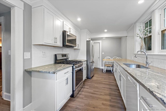 203 Ridgewood Ave, Hamden, CT 06517 - kitchen with appliances with stainless steel finishes, tasteful backsplash, white cabinets, light stone countertops, and dark wood finished floors