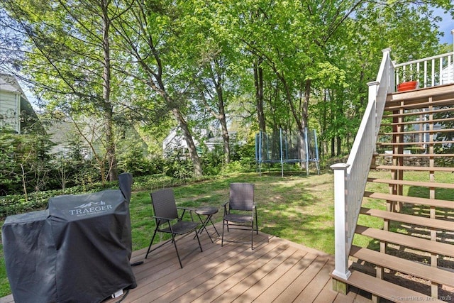 203 Ridgewood Ave, Hamden, CT 06517 - wooden deck featuring a trampoline, stairway, grilling area, and a yard