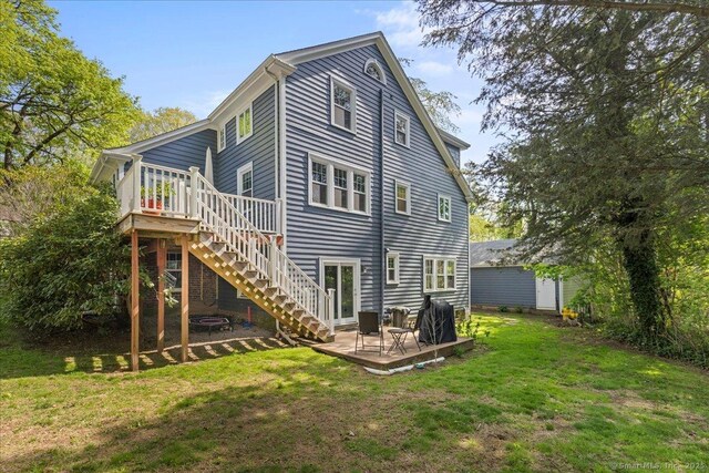 203 Ridgewood Ave, Hamden, CT 06517 - back of property with a lawn, a deck, and stairs