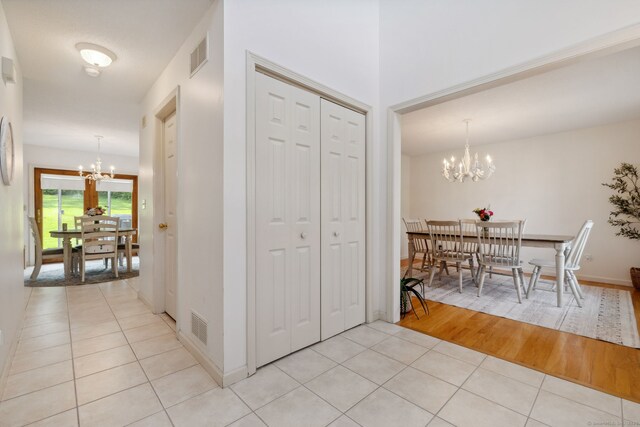 119 NW Dr, Plainville, CT 06062 - entrance foyer with a chandelier and light tile patterned floors