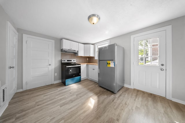 110 Asylum St, Bridgeport, CT 06610 - kitchen featuring appliances with stainless steel finishes, under cabinet range hood, white cabinetry, and light wood-style flooring