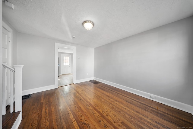 110 Asylum St, Bridgeport, CT 06610 - spare room with a textured ceiling and dark wood finished floors