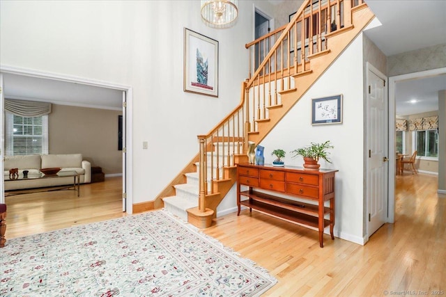9 Maplewood Dr, Danbury, CT 06811 - stairway featuring wood finished floors, a high ceiling, plenty of natural light, and a chandelier