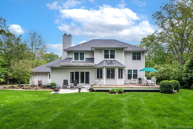 9 Maplewood Dr, Danbury, CT 06811 - rear view of house featuring a deck, a chimney, a lawn, a fire pit, and roof with shingles