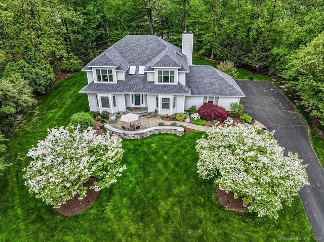 9 Maplewood Dr, Danbury, CT 06811 - view of front of home with a chimney, a front yard, and a view of trees