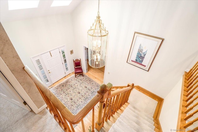 9 Maplewood Dr, Danbury, CT 06811 - foyer entrance featuring a chandelier, high vaulted ceiling, a skylight, and wood finished floors
