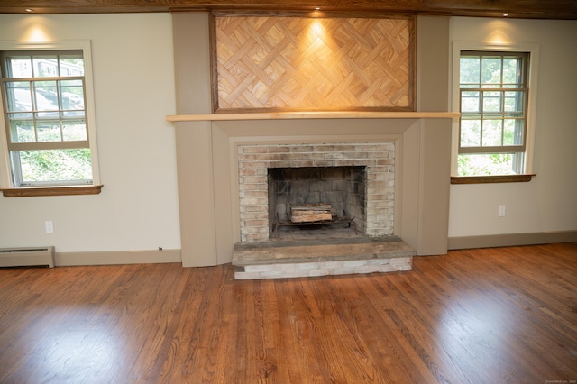 17 Valley Rd, Clinton, CT 06413 - detailed view of wood finished floors, a baseboard heating unit, and a brick fireplace