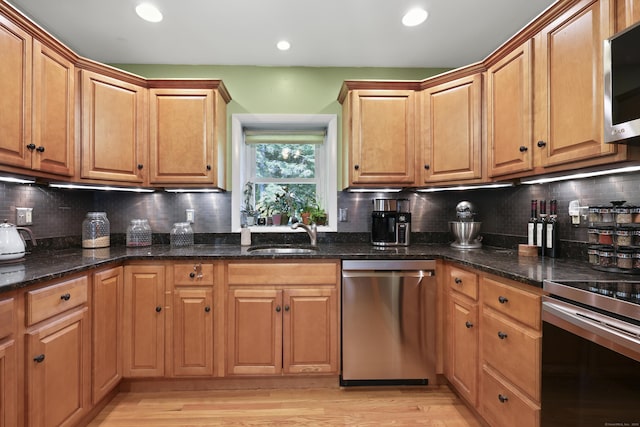 98 Aetna Ave, Torrington, CT 06790 - kitchen featuring stainless steel appliances, recessed lighting, light wood finished floors, decorative backsplash, and dark stone counters