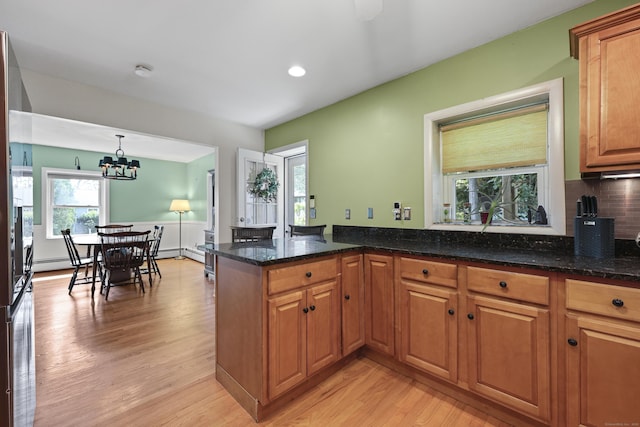 98 Aetna Ave, Torrington, CT 06790 - kitchen featuring light wood-style flooring, dark stone countertops, brown cabinets, decorative backsplash, and recessed lighting