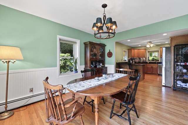 98 Aetna Ave, Torrington, CT 06790 - dining room with a chandelier, wainscoting, light wood finished floors, and a baseboard radiator