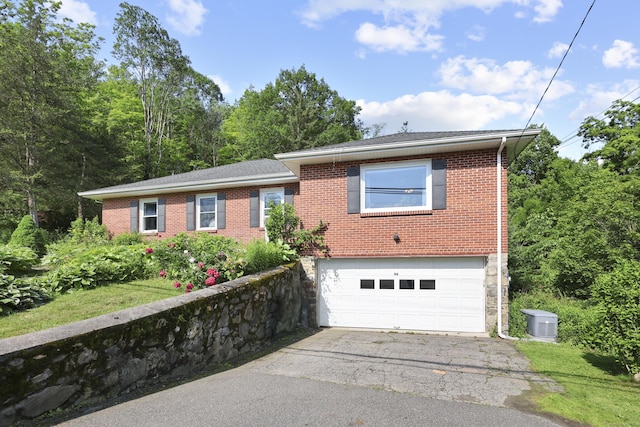 98 Aetna Ave, Torrington, CT 06790 - view of front of house with a garage, brick siding, and asphalt driveway