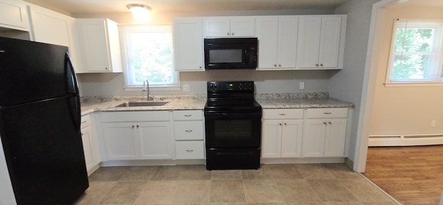 159 Windsorville Rd, South Windsor, CT 06074 - kitchen with black appliances, a baseboard radiator, and white cabinets