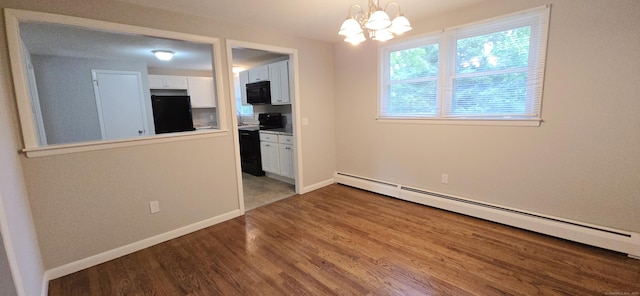 159 Windsorville Rd, South Windsor, CT 06074 - unfurnished room featuring a baseboard heating unit, wood finished floors, and a chandelier
