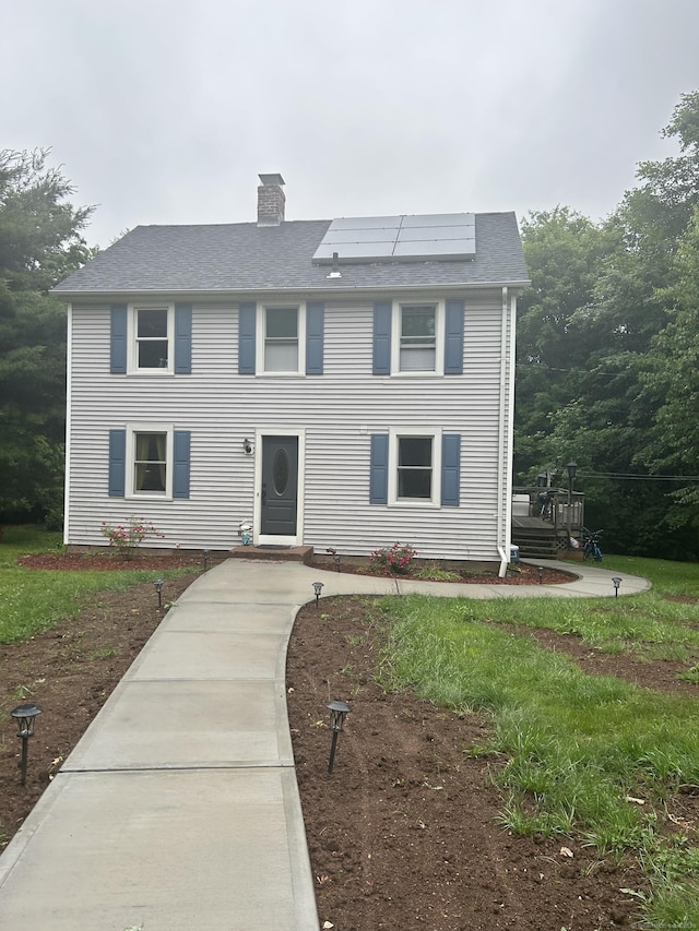 5 Sunnyslope Dr, Middletown, CT 06457 - view of front of home featuring a chimney and roof mounted solar panels