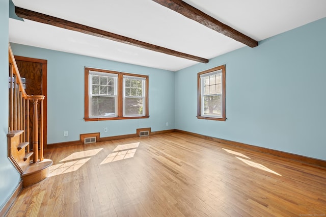 32 Franklin St, Southington, CT 06479 - unfurnished living room with stairs, healthy amount of natural light, light wood-style flooring, and beam ceiling