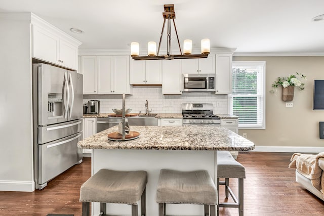 131 Long Hill Cross Rd, Shelton, CT 06484 - kitchen with appliances with stainless steel finishes, a kitchen breakfast bar, backsplash, dark wood-type flooring, and white cabinets
