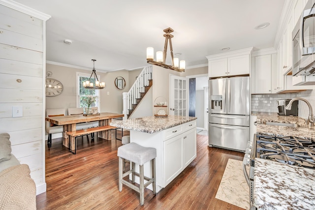 131 Long Hill Cross Rd, Shelton, CT 06484 - kitchen featuring stainless steel appliances, a chandelier, ornamental molding, and white cabinets