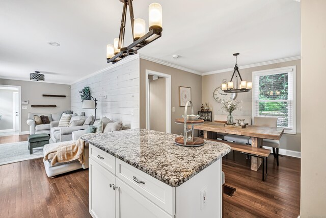 131 Long Hill Cross Rd, Shelton, CT 06484 - kitchen with a chandelier, dark wood finished floors, crown molding, light stone counters, and white cabinetry