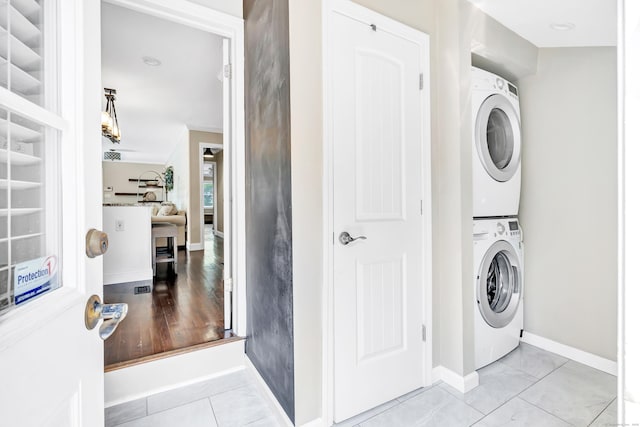 131 Long Hill Cross Rd, Shelton, CT 06484 - washroom featuring stacked washer and clothes dryer and tile patterned floors