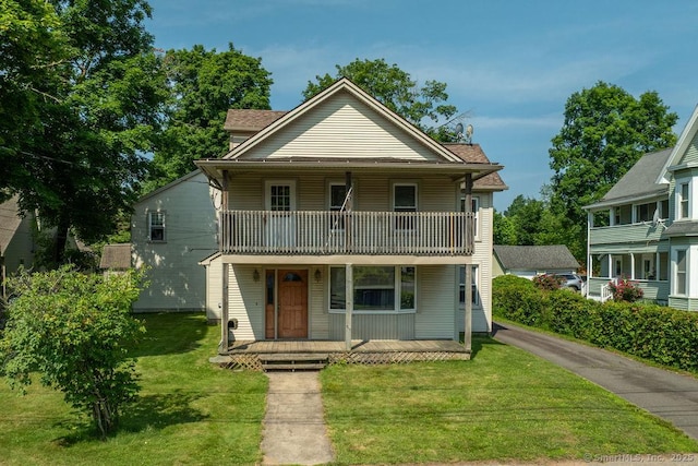 23 Church St, Plainville, CT 06062 - view of front of property featuring a balcony, a porch, and a front lawn