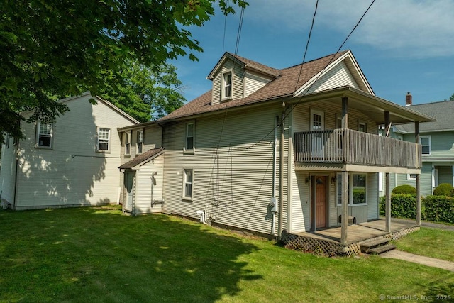 23 Church St, Plainville, CT 06062 - rear view of house with a balcony, a lawn, and a shingled roof