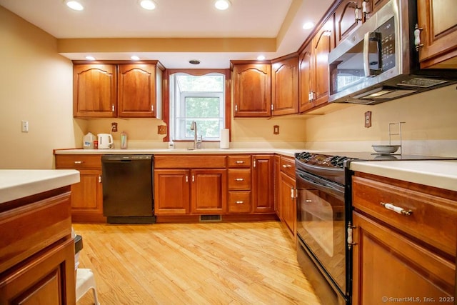 23 Church St, Plainville, CT 06062 - kitchen with black appliances, light wood finished floors, brown cabinets, and recessed lighting
