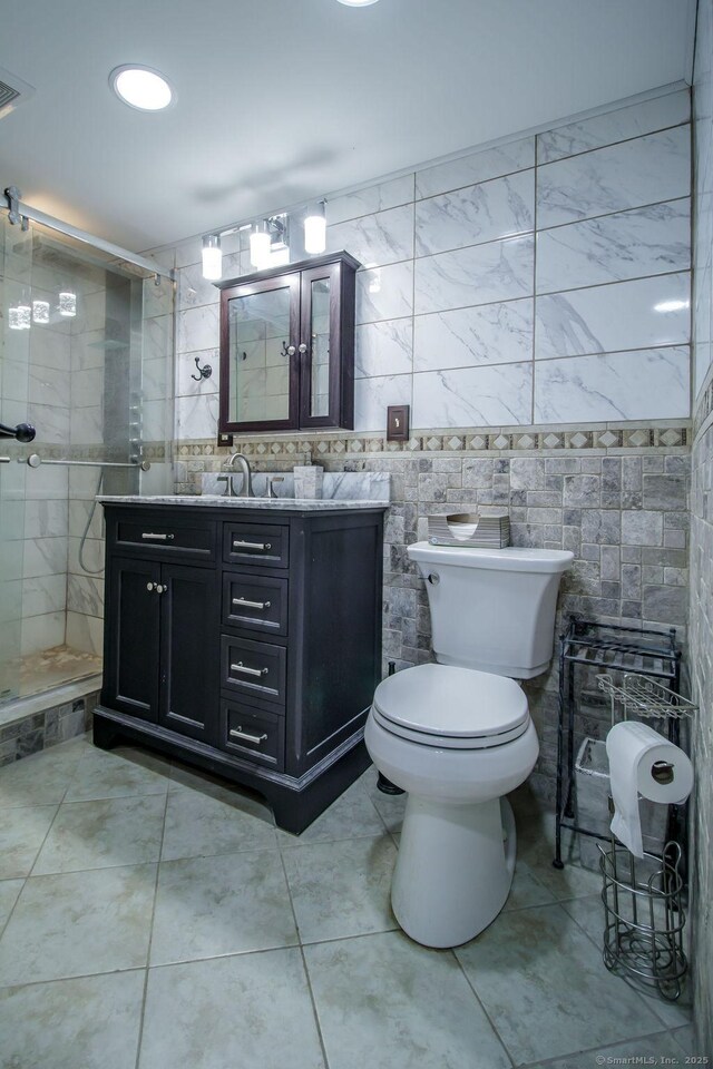 23 Church St, Plainville, CT 06062 - full bath featuring vanity, tile walls, tile patterned flooring, and a tile shower