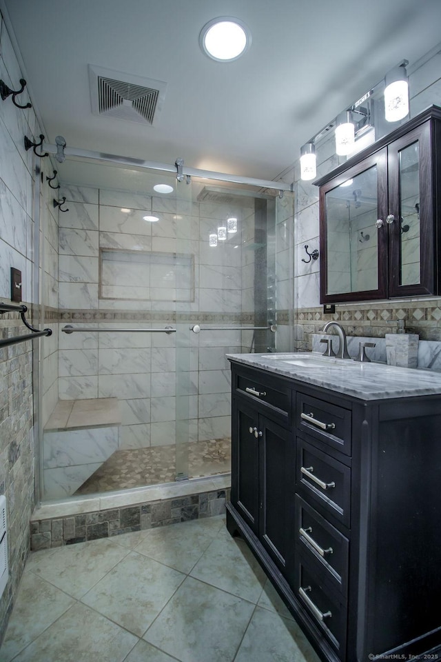 23 Church St, Plainville, CT 06062 - bathroom with a shower stall, vanity, tile walls, and tile patterned floors