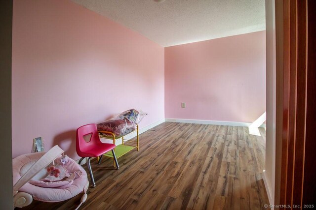 23 Church St, Plainville, CT 06062 - sitting room with wood finished floors and a textured ceiling