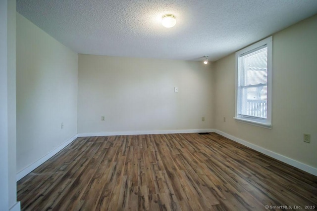 23 Church St, Plainville, CT 06062 - unfurnished room with a textured ceiling and dark wood-type flooring