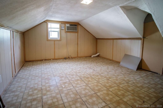 23 Church St, Plainville, CT 06062 - bonus room featuring lofted ceiling, a wall mounted air conditioner, and wood walls
