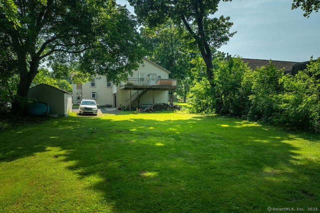 23 Church St, Plainville, CT 06062 - view of grassy yard with stairs and a deck