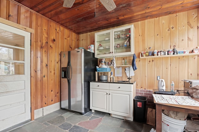 24 Appletree Ln, Norwalk, CT 06850 - kitchen with stainless steel refrigerator with ice dispenser, dark stone finish flooring, wood walls, wood ceiling, and glass insert cabinets