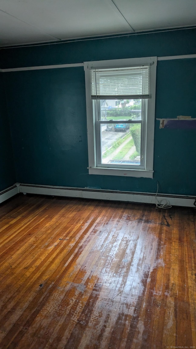 44 Convent Ave, Norwich, CT 06360 - empty room featuring wood-type flooring and a baseboard heating unit